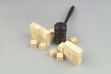 Wooden judge gavel breaking bricks wall. Freedom concept.