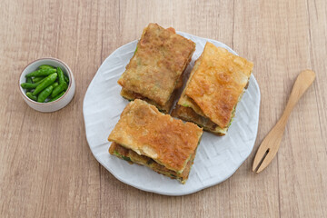 Martabak, Martabak Telor or Martabak Telur. Savory pan-fried pastry stuffed with egg, meat and spices. Martabak Telur is one of Indonesia street food. 
