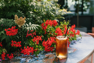 Americano with ice cubes and tonic  in glass. Summer refreshing menu in coffee shop.
