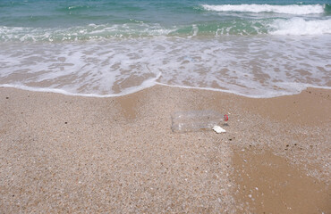Plastic water bottles pollution on beach (Environment concept)