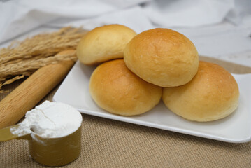 Fresh fragrant bread and bun on the table with copy space. Food concept