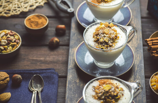 Arabic Cuisine; Traditional Middle Eastern sweet milk pudding "Sahlab", A delicious thick creamy white winter drink served with cinnamon, roasted mixed nuts and raisins.  