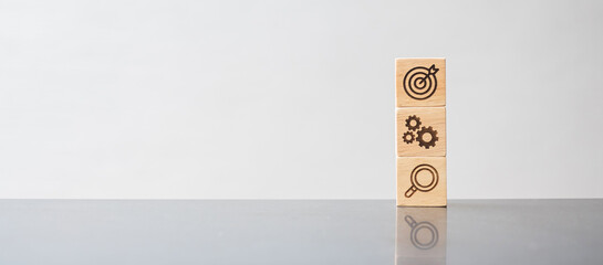 wood block with business goal, strategy, target, mission, action, objective, teamwork, brainstorm...