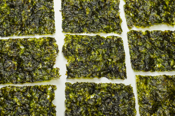Tasty nori seaweed isolated on white.