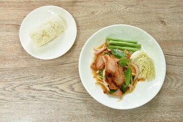 Thai spicy slice barbecue pork neck salad eat couple fresh cabbage and yard long bean on plate with sticky rice 