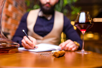 arabian man sommelier appreciating drink in lux hotel