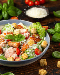 Salmon Caesar salad with grilled fish, croutons and cherry tomatoes