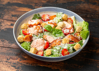 Salmon Caesar salad with grilled fish, croutons and cherry tomatoes