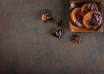 Candied oranges with chocolate. Dryed oranges and cinnamon. Top view with copyspace.