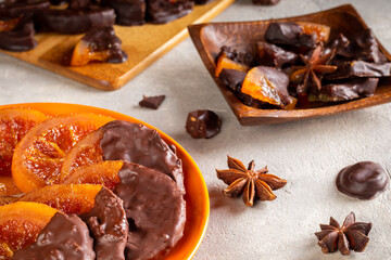 Candied oranges with chocolate. Dryed oranges and cinnamon.