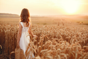 Cute little girl playing in a summer wheat field © prostooleh