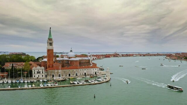 Aerial view panoramic shot coastline busy port seafaring historical attractions city Venice in Italy Doge's Palace famed San Marco public square Piazza architecture landmark famous tourist destination