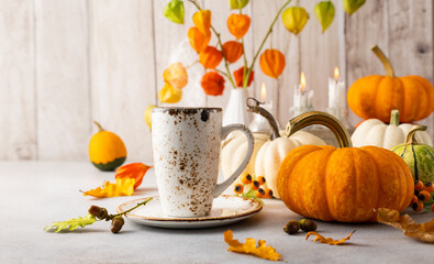 Autumn still life with pumpkins, flowers and candles on table.Thanksgiving day or halloween concept.