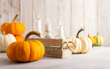 Autumn still life with pumpkins and candles on table.Thanksgiving day or halloween concept
