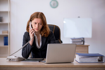 Young female employee working in the office