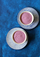 Homemade blueberry yogurt in ceramic bowl. Healthy breakfast on a table. Balanced diet concept. 