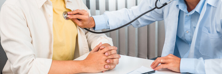 Doctor listening to patients breathing sound with Stethoscope