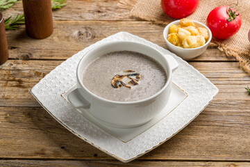 Cream soup of mushrooms on old wooden table