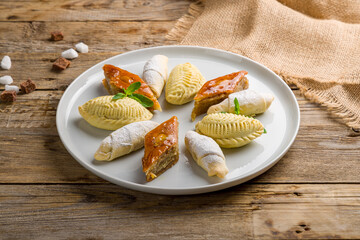 baklava with walnuts, mutaki, bureki, on wooden table. Turkish cuisine
