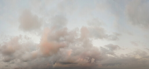 Cloudy sky before thunderstorm with red and gray color clouds, panoramic background.