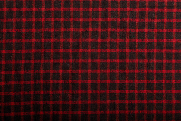 dark red and black checkboard pattern shirt fabric background, garment texture