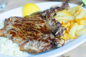 Close up on beef steak with fries
