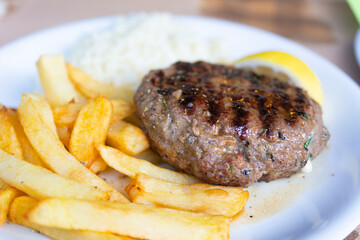 Close up on burger with fries