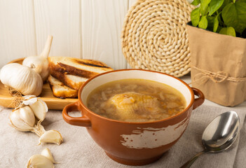 Buckwheat soup with carrots, potatoes and chicken on a white wooden table. Healthy food. Soup with croutons, garlic and spices. Copy space.