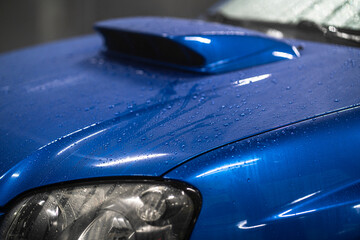 car shiny hydrophobic coating, close up waterdrops on the automobile
