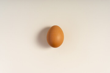 Whole raw egg in white bowl. Top view. Broken White Background.