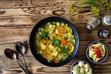 Cauliflower soup on wooden table
