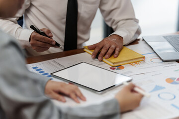 Administration or Accountant discussing with partner are meeting to audit finance planning sales to meet targets set in next year. Finance concept.