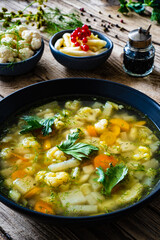 Cauliflower soup on wooden table
