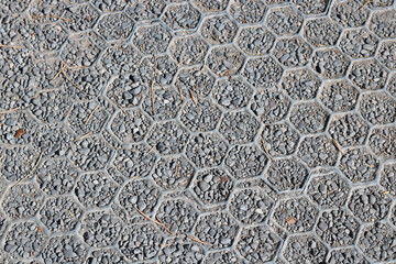Plastic and gravel hardstanding over grass with hexagonal design - image
