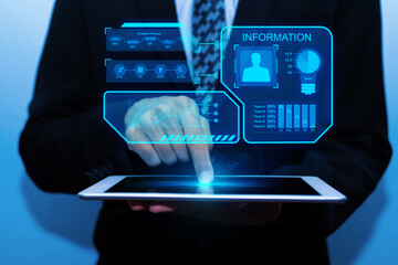 business man investor hand touching on digital mobile tablet with virtual graphic icon diagram on dark background, digital marketing, internet connection, business finance, network technology concept