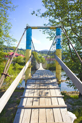 Wooden suspension bridge over the Black Cheremysh River in  Verkhovyna, Ukraine