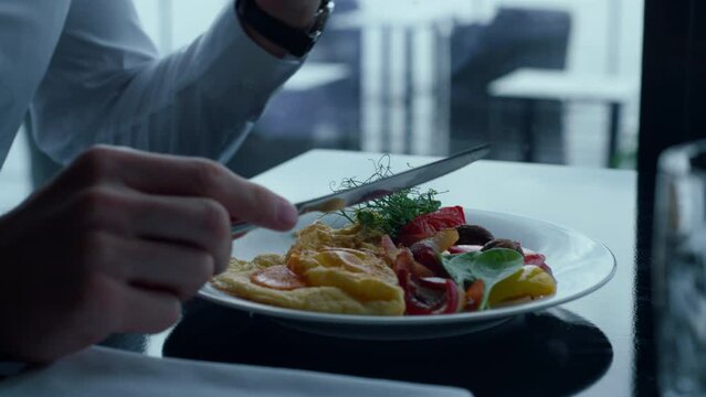 Successful businessman enjoying fresh healthy meal in luxury hotel cafe