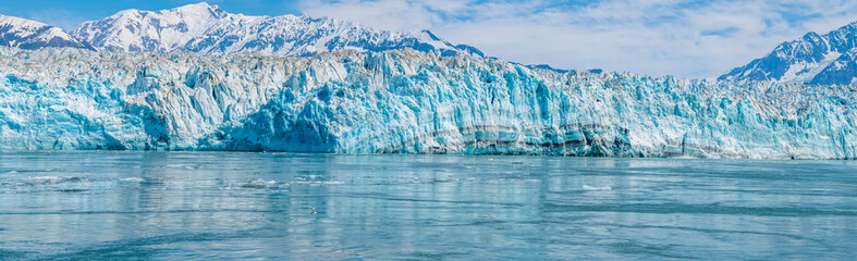 A panorama view in Disenchartment Bay across the snout of the Hubbard Glacier, Alaska in summertime