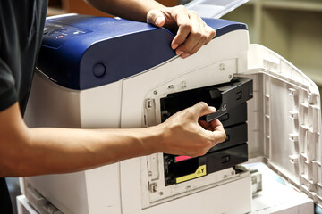 Technician hand open cover photocopier or photocopy to fix paper jam and replace ink cartridges for...