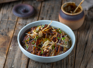 GYUDON donburi served in a dish isolated on wooden background side view of japanese food
