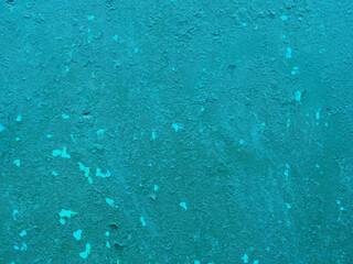 View of old peeling blue paint on the wall.