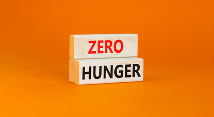 Zero hunger symbol. Concept words Zero hunger on wooden blocks on a beautiful orange table orange...