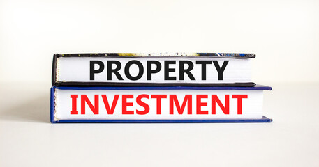 Property investment symbol. Concept words Property investment on books on a beautiful white table white background. Business Property investment concept. Copy space.