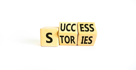Success stories symbol. Concept words Success stories on wooden cubes. Beautiful white table white...