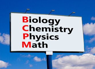 BCPM biology chemistry physics math symbol. Concept words BCPM biology chemistry physics math on white billboard against blue sky. Business BCPM biology chemistry physics math concept.