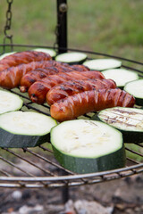 Sausages and zucchini  being barbequed	