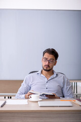 Fototapeta premium Young male teacher in the classroom