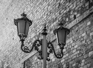 lantern against stone wall in black and white