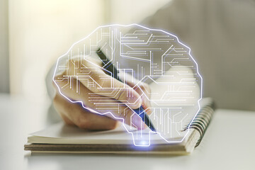 Creative artificial Intelligence concept with human brain hologram and man hand writing in notebook...