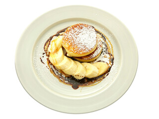 Tasty pancakes with banana and chocolate sauce on plate Isolated on white background.